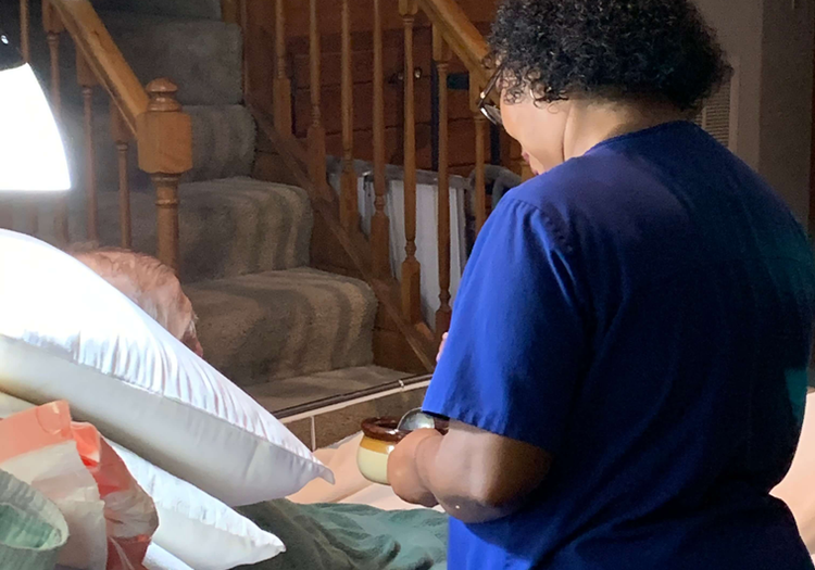 Moore Care Caregiver taking care of a patient