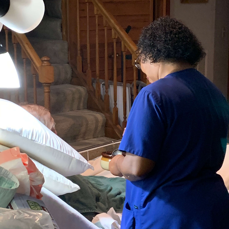 Moore Care Caregiver taking care of a patient