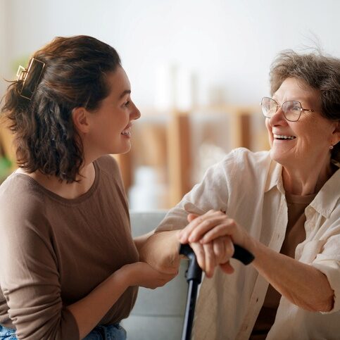 Adult daughter checking in with her aging mother at home, a sign it may be time for in-home care